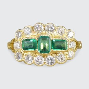 Emerald and diamond boat ring in gold.