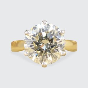 Solitaire diamond engagement ring in white and yellow gold.