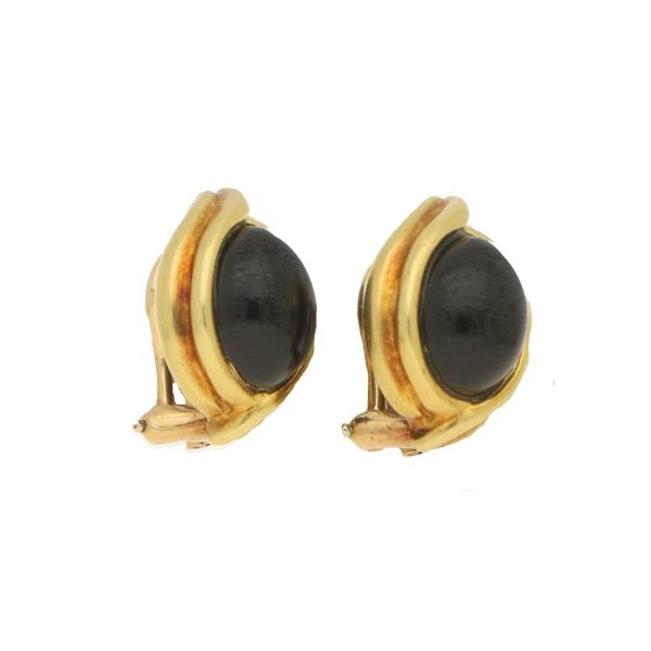 Onyx cabochon clip-on earrings in gold.