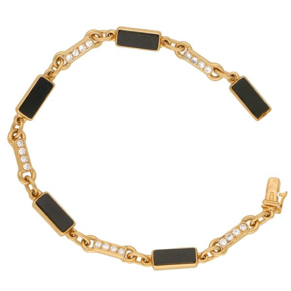 Van Cleef and Arpels onyx and diamond chain link bracelet in gold.