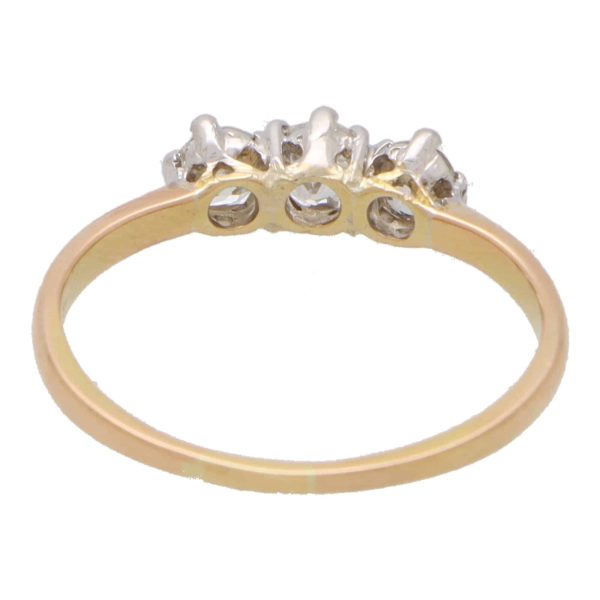 Vintage three stone diamond ring set in yellow and rose gold.