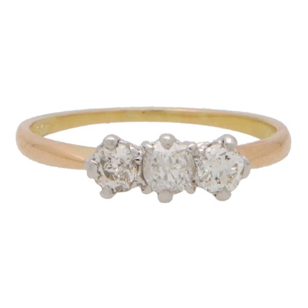 Vintage three stone diamond ring set in yellow and rose gold.