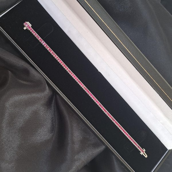 Channel Set Square Princess Cut Ruby Line Tennis Bracelet in 18ct White Gold, 6.56 carat total