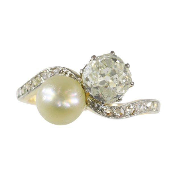 Antique Toi et Moi diamond and pearl in gold and platinum.