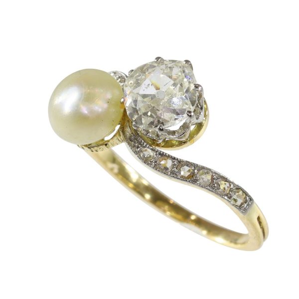 Antique Toi et Moi diamond and pearl in gold and platinum.