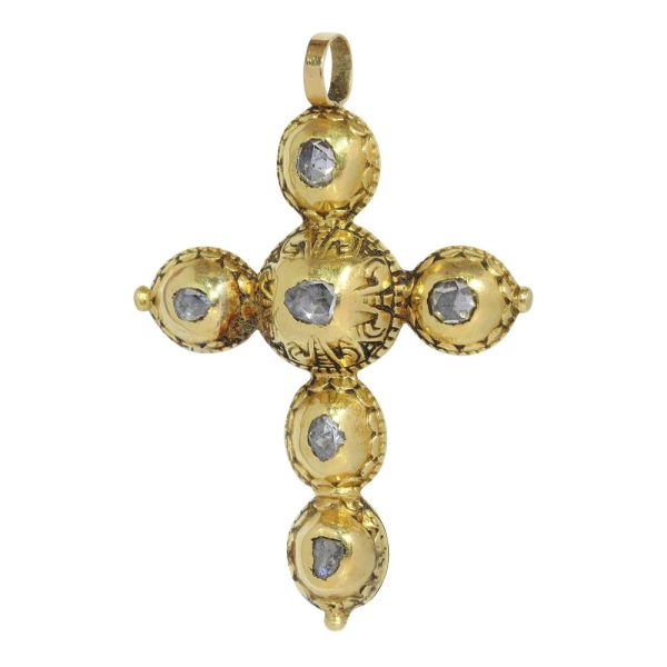 Baroque diamond cross pendant in gold.