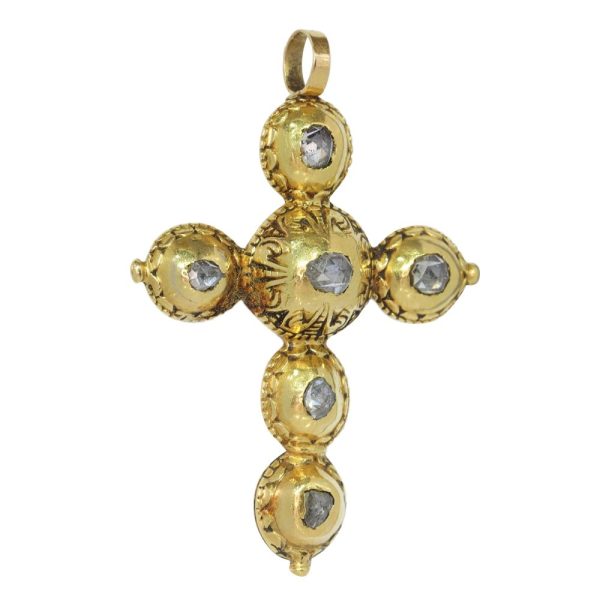 Baroque diamond cross pendant in gold.