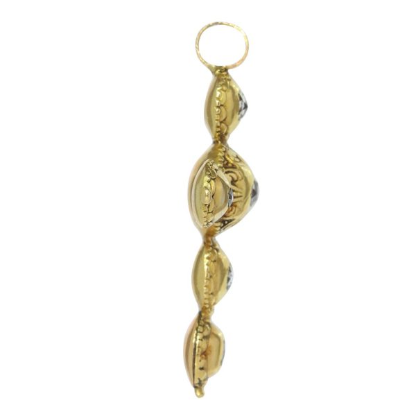 Baroque diamond cross pendant in gold.