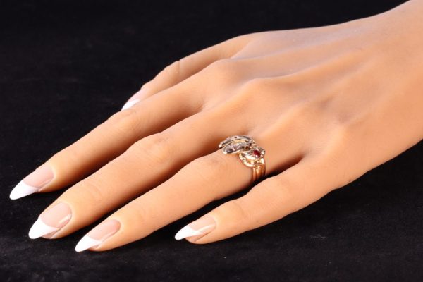 Victorian serpent ring in gold with three gemstones.