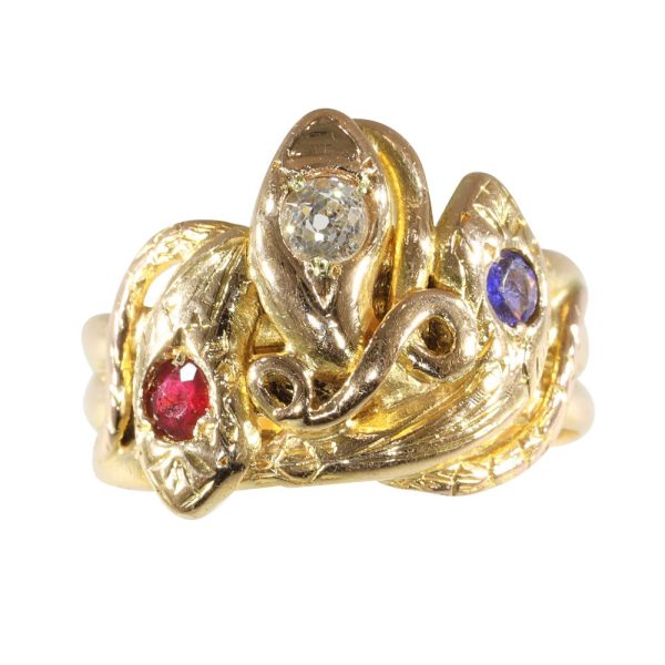 Victorian serpent ring in gold with three gemstones.