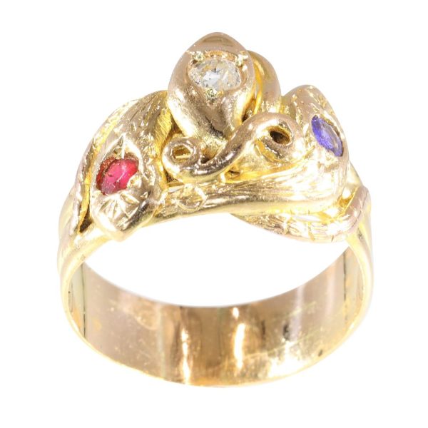 Victorian serpent ring in gold with three gemstones.