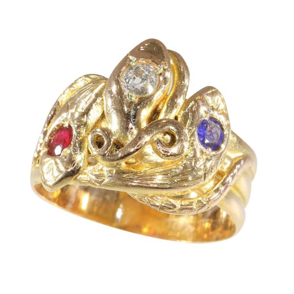 Victorian serpent ring in gold with three gemstones.