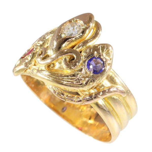 Victorian serpent ring in gold with three gemstones.