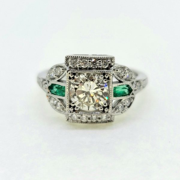 Vintage 0.96ct Diamond and Emerald Cluster Engagement Ring, 0.96ct diamond flanked top and bottom by diamond border in 18ct white gold with emerald and diamond fleur-de-lis shoulders