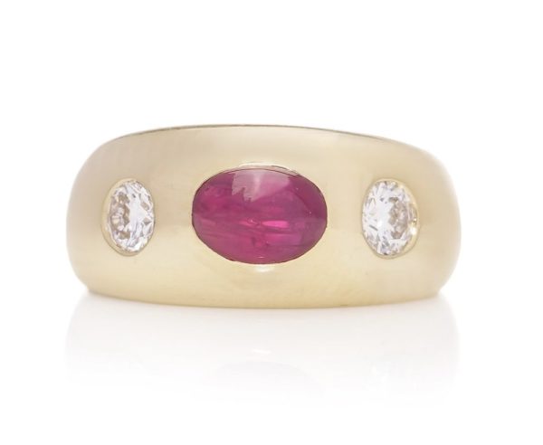 Bulgari 18ct. yellow gold gypsy set three stone ring, set with oval 1.29 cts. of Natural Burma cabochon ruby and 0.40 cts. of round Old-European cut diamonds.