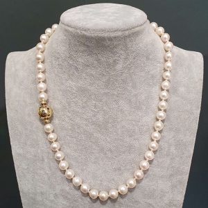 Vintage Italian Akoya Pearl Necklace, Akoya Japanese cultured pearls on 18ct gold ball clasp set with small rubies, sapphires and emeralds. Circa 1980s