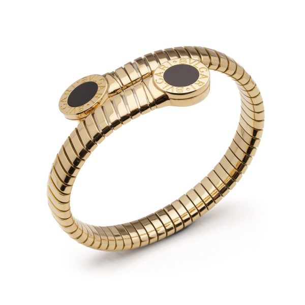 Vintage Bvlgari 18ct Yellow Gold and Onyx Tubogas Bangle Bracelet, 18ct yellow gold tubogas flexible sprung cuff made of coiled gas pipe links with terminals of circular onyx plaques encased in a polished surround engraved with the BVLGARI BVLGARI motif. Made in Italy, Alexandria, Circa 1990s