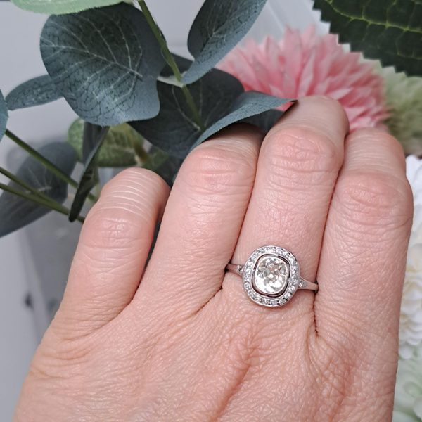 Antique 1.50ct Cushion Old Cut Diamond Halo Cluster Engagement Ring in platinum. Circa 1900s