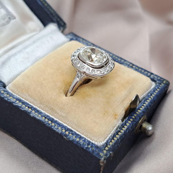 Antique 1.50ct Cushion Old Cut Diamond Halo Cluster Engagement Ring in platinum. Circa 1900s