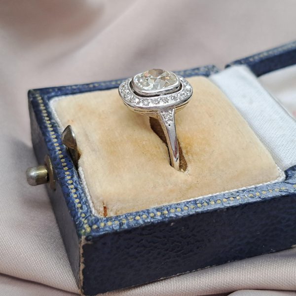 Antique 1.50ct Cushion Old Cut Diamond Halo Cluster Engagement Ring in platinum. Circa 1900s