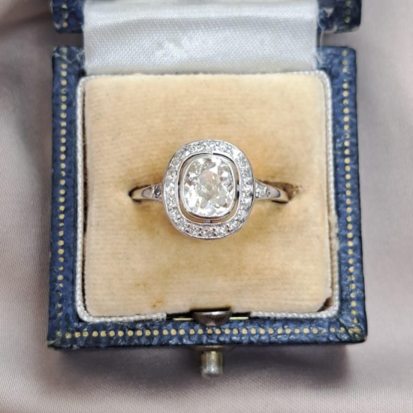 Antique 1.50ct Cushion Old Cut Diamond Halo Cluster Engagement Ring in platinum. Circa 1900s