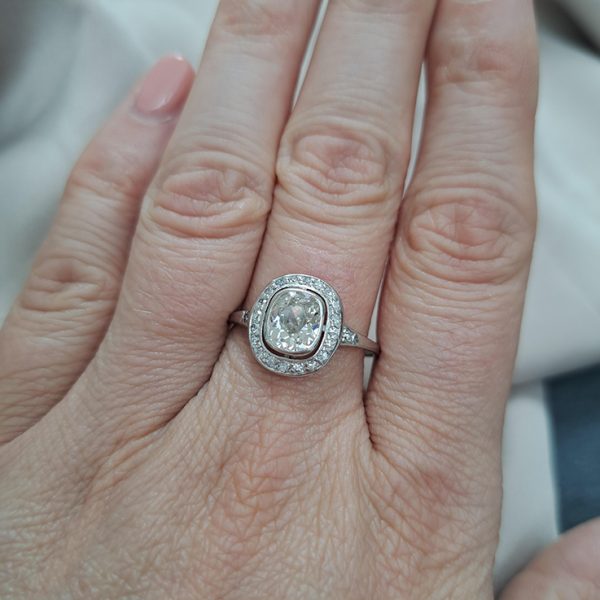 Antique 1.50ct Cushion Old Cut Diamond Halo Cluster Engagement Ring in platinum. Circa 1900s