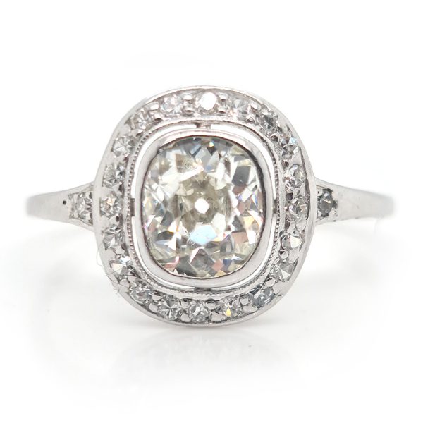 Antique 1.50ct Cushion Old Cut Diamond Halo Cluster Engagement Ring in platinum. Circa 1900s