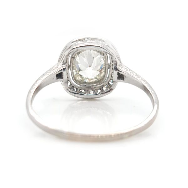 Antique 1.50ct Cushion Old Cut Diamond Halo Cluster Engagement Ring in platinum. Circa 1900s