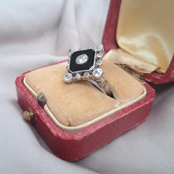 Late Art Deco Onyx and Diamond Cluster Ring in platinum and white gold. Circa 1930s