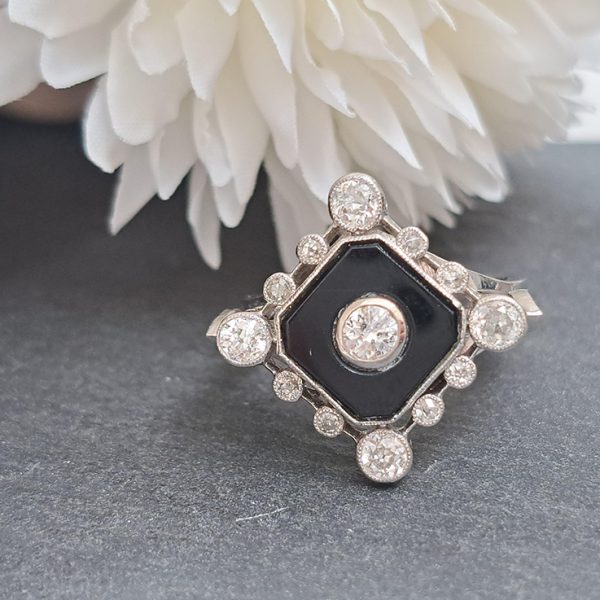 Late Art Deco Onyx and Diamond Cluster Ring in platinum and white gold. Circa 1930s