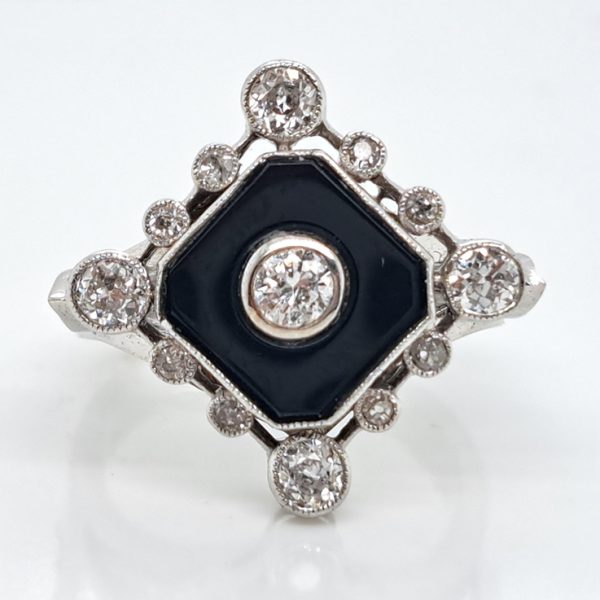 Late Art Deco Onyx and Diamond Cluster Ring in platinum and white gold. Circa 1930s