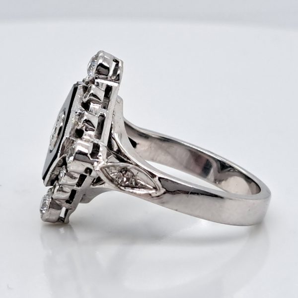 Late Art Deco Onyx and Diamond Cluster Ring in platinum and white gold. Circa 1930s