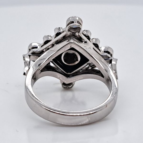 Late Art Deco Onyx and Diamond Cluster Ring in platinum and white gold. Circa 1930s