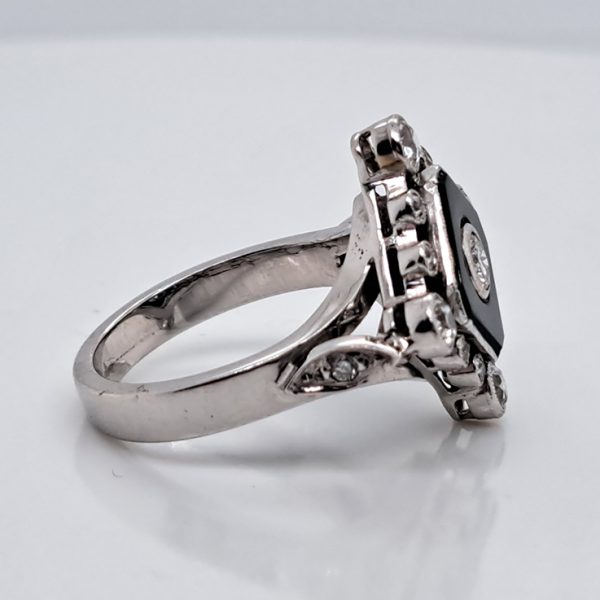 Late Art Deco Onyx and Diamond Cluster Ring in platinum and white gold. Circa 1930s