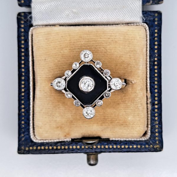 Late Art Deco Onyx and Diamond Cluster Ring in platinum and white gold. Circa 1930s