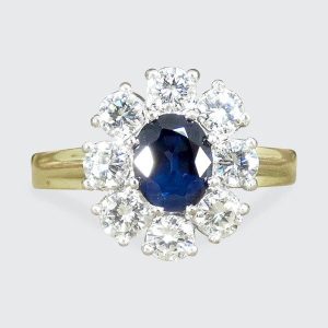 Sapphire and diamond oval cluster ring in yellow and white gold.