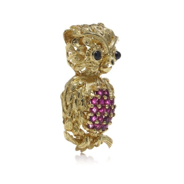 Vintage owl brooch with rubies and sapphires in gold.