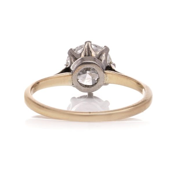 Diamond solitaire ring in gold and silver.