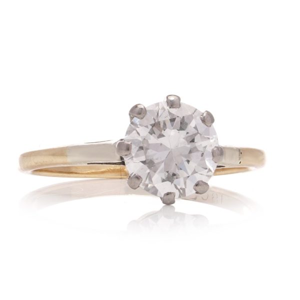 Diamond solitaire ring in gold and silver.