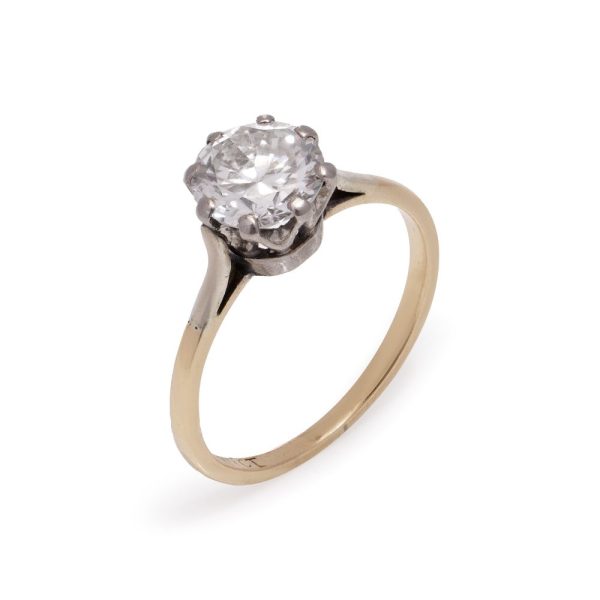 Diamond solitaire ring in gold and silver.