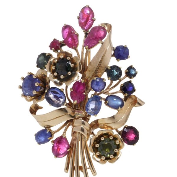 Multi coloured gem flower brooch in gold.