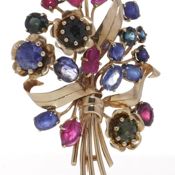 Multi coloured gem flower brooch in gold.