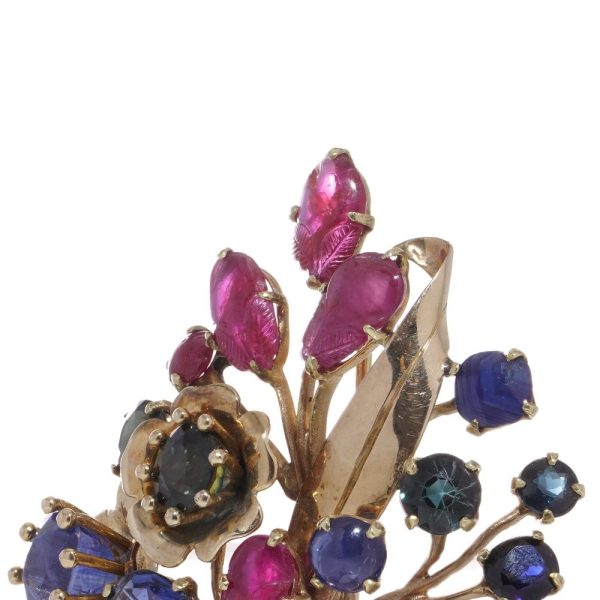 Multi coloured gem flower brooch in gold.