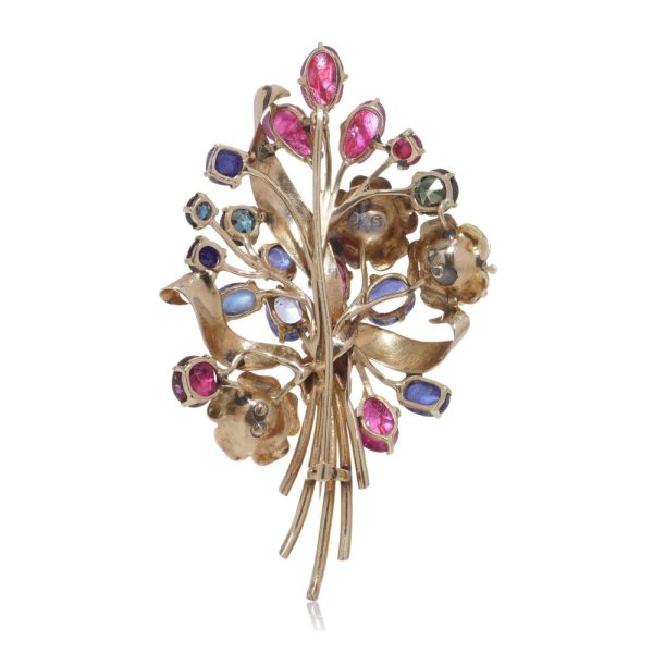 Multi coloured gem flower brooch in gold.