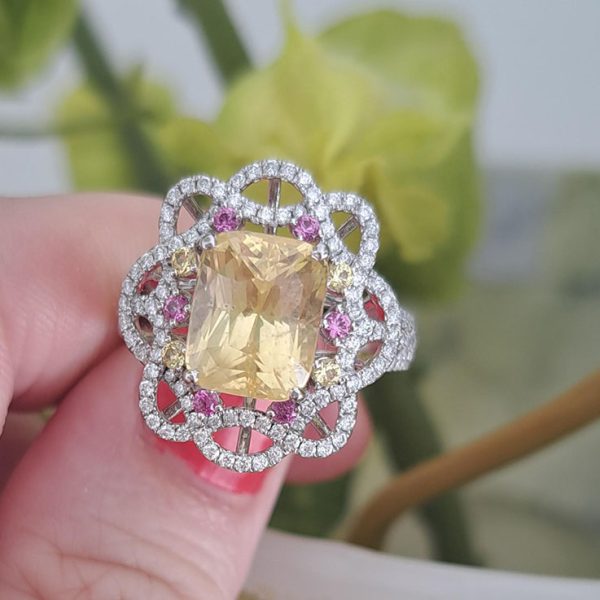 5.08ct Natural No Heat Yellow Sapphire Cluster Ring, cushion-shaped mixed-cut certified natural yellow sapphire with no indications of heat treatment surrounded by diamonds with yellow and pink sapphire accents in a contemporary flower design in platinum