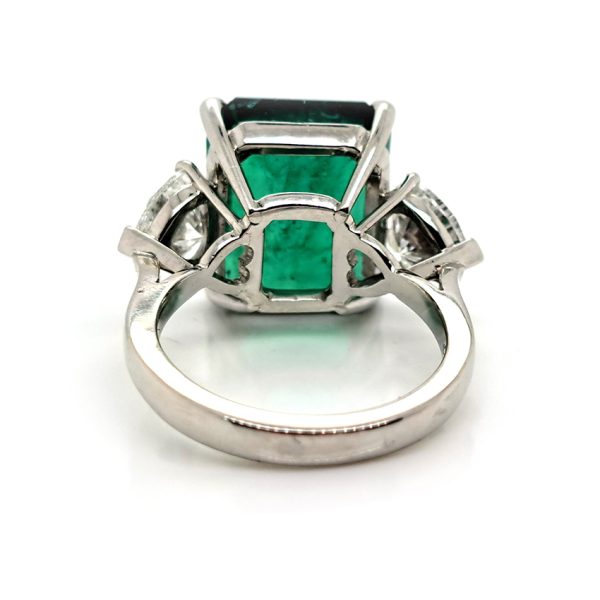 9ct Zambian Emerald and Heart Diamond Three Stone Ring with GIA Certificates, 9.08ct emerald-cut Zambian emerald flanked by GIA certified heart shaped diamonds in platinum