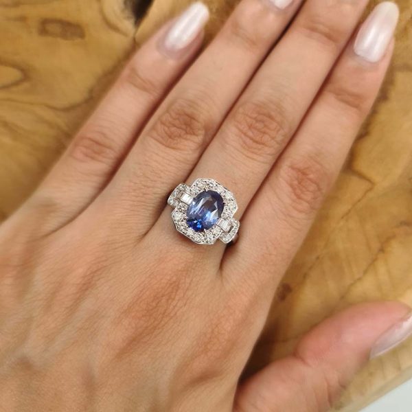 2ct Oval Sapphire and Diamond Cluster Ring, 2.02ct oval blue sapphire surrounded by diamonds with diamond buckle design shoulders