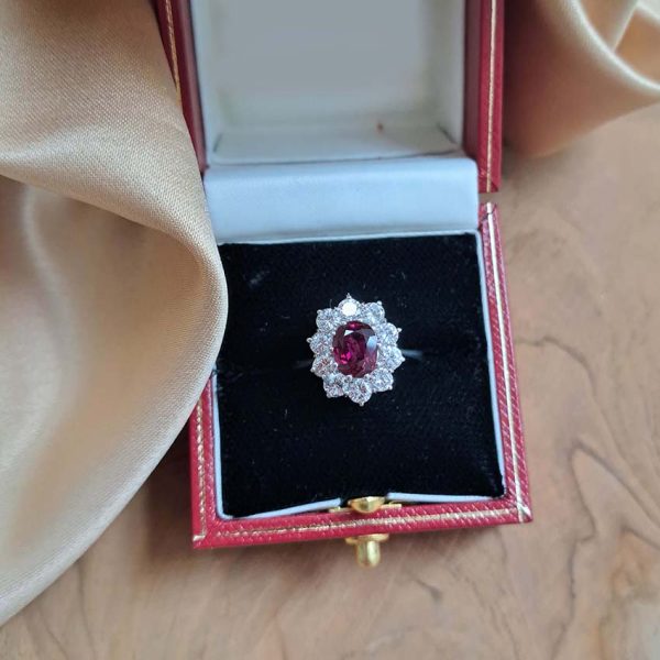 Natural No Heat Ruby and Diamond Cluster Engagement Ring, oval-cut Thai ruby with no indication of heat treatment surrounded by 1ct sparkling round brilliant-cut diamonds in 18ct white gold