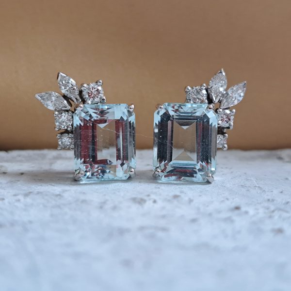 6ct Aquamarine and Diamond Stud Earrings, emerald-cut aquamarine with brilliant-cut and marquise-cut diamond corner highlights in decorative leaf design in 18ct white gold