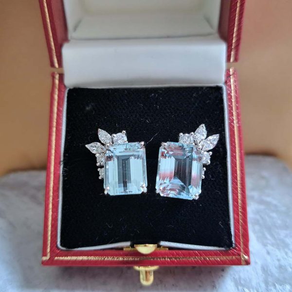 6ct Aquamarine and Diamond Stud Earrings, emerald-cut aquamarine with brilliant-cut and marquise-cut diamond corner highlights in decorative leaf design in 18ct white gold